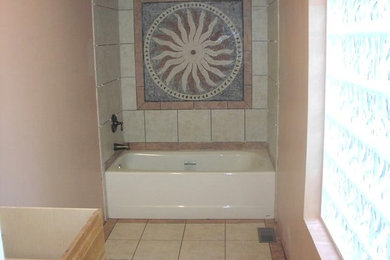 Multicolored tile and ceramic tile travertine floor bathroom photo in Raleigh with pink walls