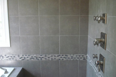 Gray tile and ceramic tile doorless shower photo in Raleigh