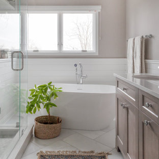 Example of a mid-sized transitional master white tile and marble tile marble floor, white floor, double-sink, vaulted ceiling and shiplap wall bathroom design in Chicago with shaker cabinets, gray cabinets, a two-piece toilet, gray walls, a drop-in sink, quartz countertops, a hinged shower door, white countertops and a freestanding vanity