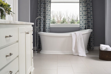 Example of a large trendy master porcelain tile and beige floor freestanding bathtub design in Minneapolis with furniture-like cabinets, white cabinets, gray walls and quartz countertops