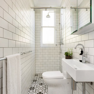 This is an example of a transitional bathroom in Sydney with white tile, subway tile, a console sink, multi-coloured floor and a single vanity.