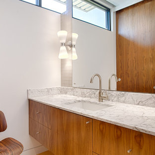 This is an example of a modern 3/4 bathroom in Oklahoma City with flat-panel cabinets, orange cabinets, gray tile, ceramic tile, white walls, an undermount sink and marble benchtops.