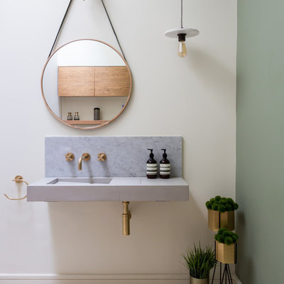 Danish multicolored floor bathroom photo in London with white walls, an integrated sink and gray countertops