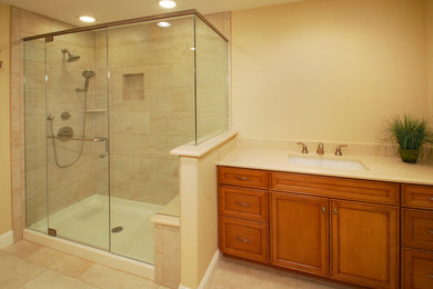 Corner shower - mid-sized traditional beige tile and ceramic tile ceramic tile corner shower idea in Denver with beige walls
