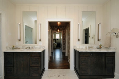 Inspiration for a large timeless master marble floor and white floor bathroom remodel in Nashville with recessed-panel cabinets, dark wood cabinets, white walls, an undermount sink and marble countertops