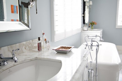 Example of a white tile bathroom design in Charlotte with white cabinets
