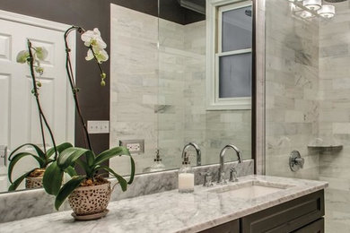 Transitional gray tile and stone tile bathroom photo in Toronto with recessed-panel cabinets, dark wood cabinets and marble countertops