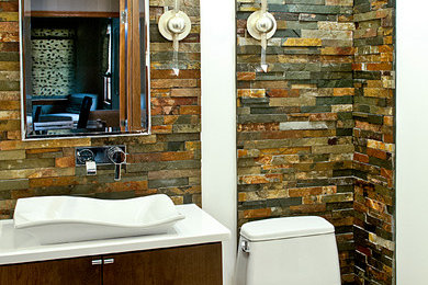 Example of a mid-sized trendy master brown tile and stone tile porcelain tile bathroom design in Boston with a vessel sink, flat-panel cabinets, dark wood cabinets, quartz countertops and brown walls