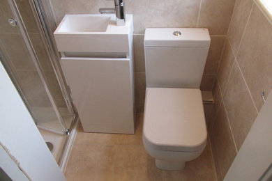 Small contemporary ensuite bathroom in Other with freestanding cabinets, white cabinets, a built-in shower, a two-piece toilet, beige tiles, ceramic tiles, beige walls and ceramic flooring.