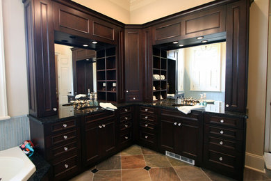 This is an example of an ensuite bathroom in New Orleans with a submerged sink, flat-panel cabinets, dark wood cabinets, engineered stone worktops and ceramic flooring.