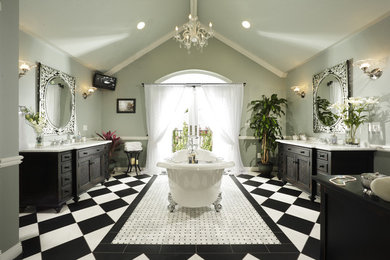 Modelo de cuarto de baño clásico con armarios con paneles empotrados, puertas de armario negras y bañera con patas