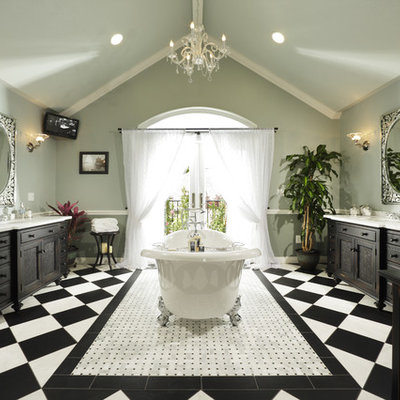 Claw-foot bathtub - traditional claw-foot bathtub idea in Sacramento with recessed-panel cabinets and black cabinets