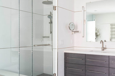Inspiration for a huge contemporary white tile and ceramic tile ceramic tile and gray floor corner shower remodel in Boston with flat-panel cabinets, dark wood cabinets, white walls, an undermount sink, quartz countertops, a hinged shower door and white countertops
