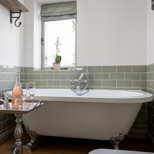 Inspiration for a medium sized classic bathroom in Gloucestershire with a freestanding bath, green tiles, metro tiles, white walls, medium hardwood flooring and brown floors.
