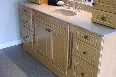 Elegant bathroom photo in Toronto with an integrated sink, beaded inset cabinets, distressed cabinets and solid surface countertops