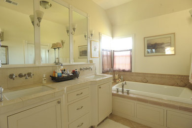 Bathroom - beige tile bathroom idea in San Francisco with white cabinets