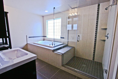 Mid-sized minimalist master beige tile and porcelain tile porcelain tile bathroom photo in Denver with an integrated sink, flat-panel cabinets, black cabinets, solid surface countertops and white walls