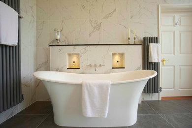 This is an example of a large traditional family bathroom in Other with a pedestal sink, a freestanding bath, a double shower and white tiles.