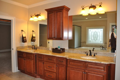 Bathroom - large master beige tile and ceramic tile ceramic tile bathroom idea in St Louis with an undermount sink, raised-panel cabinets, medium tone wood cabinets, granite countertops and beige walls