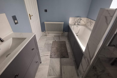 Design ideas for a modern bathroom in Surrey with grey cabinets, a walk-in shower, white tiles, ceramic tiles, blue walls, travertine flooring, a submerged sink, green floors, a hinged door, a single sink and a freestanding vanity unit.