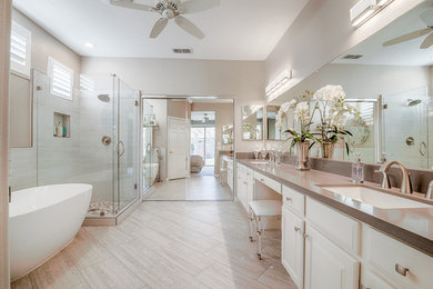 Inspiration for a mid-sized timeless master white tile and ceramic tile ceramic tile and gray floor bathroom remodel in Other with raised-panel cabinets, white cabinets, a one-piece toilet, beige walls, an undermount sink, marble countertops and a hinged shower door