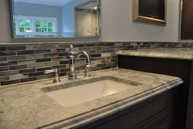 This is an example of an expansive traditional bathroom in Providence with a freestanding bath, a corner shower, dark wood cabinets, black tiles, brown tiles, glass tiles, beige walls and a submerged sink.