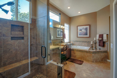 Inspiration for a mid-sized transitional master brown tile and ceramic tile ceramic tile and brown floor bathroom remodel in Other with raised-panel cabinets, dark wood cabinets, a two-piece toilet, beige walls, an undermount sink, marble countertops and a hinged shower door