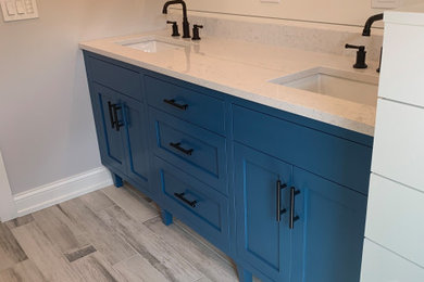 Inspiration for a large contemporary master double-sink bathroom remodel in Chicago with shaker cabinets, blue cabinets, white walls, solid surface countertops, white countertops and a built-in vanity