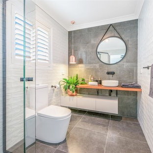 Inspiration for a mid-sized contemporary master bathroom in Brisbane with flat-panel cabinets, white cabinets, an open shower, a one-piece toilet, white tile, ceramic tile, white walls, ceramic floors, a vessel sink, wood benchtops, green floor, an open shower and brown benchtops.