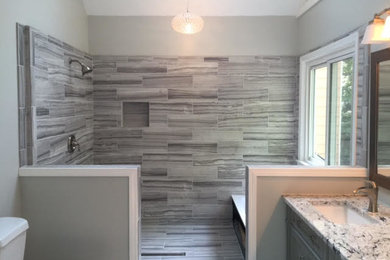 Bathroom - mid-sized contemporary master gray tile and porcelain tile porcelain tile and gray floor bathroom idea in Atlanta with recessed-panel cabinets, gray cabinets, gray walls, an undermount sink, granite countertops and gray countertops