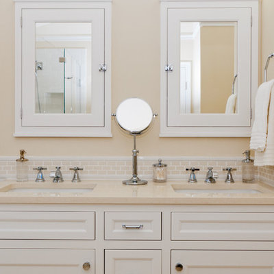 Elegant beige tile bathroom photo in DC Metro with an undermount sink, recessed-panel cabinets and white cabinets