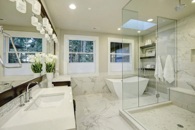 Mid-sized trendy master white tile and marble tile marble floor and white floor bathroom photo in Los Angeles with dark wood cabinets, white walls, an undermount sink, quartz countertops, a hinged shower door and white countertops