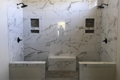 Inspiration for a large traditional ensuite bathroom in Dallas with a double shower, porcelain flooring, grey floors, shaker cabinets, black cabinets, a two-piece toilet, white tiles, marble tiles, beige walls, a submerged sink, solid surface worktops, an open shower and white worktops.