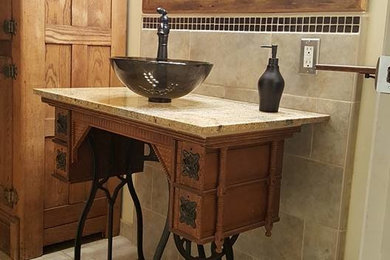 Mid-sized elegant ceramic tile and brown floor bathroom photo in Sacramento with dark wood cabinets, beige walls, a vessel sink and granite countertops