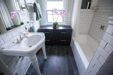 Example of a transitional master white tile and ceramic tile porcelain tile and multicolored floor bathroom design in Portland with flat-panel cabinets, dark wood cabinets, a two-piece toilet, blue walls and a console sink