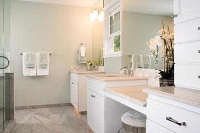 Large traditional ensuite bathroom in Seattle with raised-panel cabinets, white cabinets, a corner shower, beige tiles, pebble tiles, white walls, ceramic flooring, a submerged sink and quartz worktops.