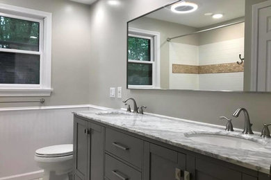 Bathroom - mid-sized transitional 3/4 white tile and ceramic tile marble floor and white floor bathroom idea in New York with recessed-panel cabinets, gray cabinets, a two-piece toilet, gray walls, an undermount sink, granite countertops and gray countertops