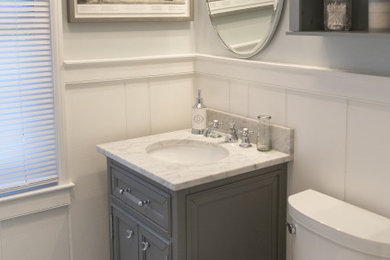 Example of a mid-sized classic 3/4 mosaic tile floor and gray floor bathroom design in Baltimore with raised-panel cabinets, gray cabinets, a two-piece toilet, white walls, granite countertops and white countertops