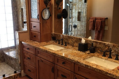 Example of a tuscan master bathroom design in San Diego with granite countertops