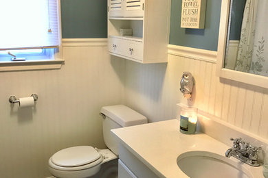 Small farmhouse 3/4 white tile and ceramic tile porcelain tile bathroom photo in Providence with white cabinets, a one-piece toilet, blue walls, an undermount sink and quartz countertops
