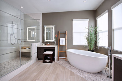 This is an example of a large modern ensuite bathroom in Los Angeles with dark wood cabinets, a freestanding bath, an alcove shower, brown walls, vinyl flooring, quartz worktops, beige floors and a hinged door.