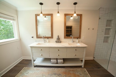 Example of a large minimalist master white tile and subway tile dark wood floor and brown floor corner shower design in Atlanta with furniture-like cabinets, white cabinets, a one-piece toilet, gray walls, an undermount sink, marble countertops and a hinged shower door