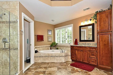 Mid-sized master beige tile and ceramic tile ceramic tile bathroom photo in DC Metro with a drop-in sink, medium tone wood cabinets, granite countertops and beige walls
