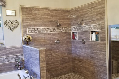 Inspiration for a mid-sized transitional master brown tile and porcelain tile porcelain tile and brown floor bathroom remodel in Dallas with beige walls
