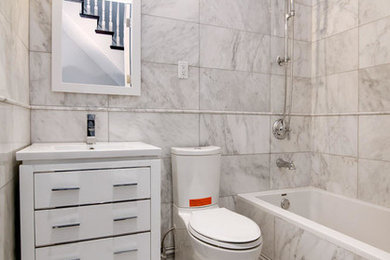 Bathroom - mid-sized contemporary master white tile and ceramic tile ceramic tile bathroom idea in New York with white cabinets, a one-piece toilet, white walls and a drop-in sink