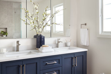 Inspiration for a mid-sized transitional master gray tile and porcelain tile gray floor, double-sink and porcelain tile bathroom remodel in San Francisco with shaker cabinets, blue cabinets, white walls, an undermount sink, white countertops, quartzite countertops, a freestanding vanity and a hinged shower door