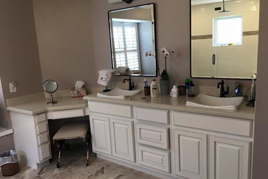 Small elegant bathroom photo in Houston with white cabinets