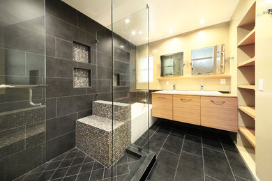 Inspiration for a contemporary master gray tile and mosaic tile ceramic tile double shower remodel in Los Angeles with a vessel sink, flat-panel cabinets, medium tone wood cabinets, wood countertops and a two-piece toilet