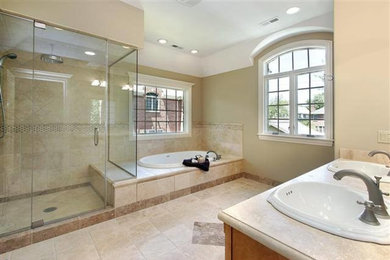 Example of a large classic master beige tile and ceramic tile ceramic tile and beige floor bathroom design in Orange County with medium tone wood cabinets, a two-piece toilet, beige walls, a drop-in sink, laminate countertops and a hinged shower door