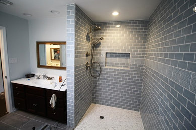 Bathroom - mid-sized contemporary blue tile and subway tile mosaic tile floor and white floor bathroom idea in Houston with black cabinets, blue walls, an integrated sink and white countertops